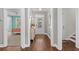 Bright hallway with hardwood floors and views into the front door and a bedroom at 1470 Suncrest Dr., Myrtle Beach, SC 29577