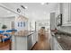 Open-concept kitchen with granite island, stainless appliances, and adjacent living area at 1470 Suncrest Dr., Myrtle Beach, SC 29577