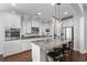 Bright kitchen boasts an island with bar seating, pendant lighting, and stainless steel appliances at 1470 Suncrest Dr., Myrtle Beach, SC 29577