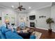 Comfortable living room featuring a fireplace, hardwood floors, and access to a bedroom and patio at 1470 Suncrest Dr., Myrtle Beach, SC 29577