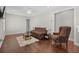 Cozy living room featuring hardwood floors, neutral colors, futon, accent chair, and coffee table at 1470 Suncrest Dr., Myrtle Beach, SC 29577