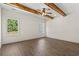 Bright bedroom with hardwood floors, ceiling fan, and exposed wood beams at 1503 Red Bluff Rd., Loris, SC 29569
