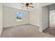 Bright bedroom features neutral walls, plush carpeting, and a window with a view at 1503 Red Bluff Rd., Loris, SC 29569