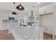 Modern kitchen with sleek white cabinetry, stainless steel appliances, and a large center island at 1503 Red Bluff Rd., Loris, SC 29569