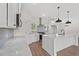 Modern kitchen featuring marble countertops, stainless steel appliances and sleek white cabinetry with natural light at 1503 Red Bluff Rd., Loris, SC 29569