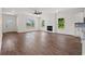 Bright open-concept living space with hardwood flooring, fireplace, and large windows overlooking yard at 1503 Red Bluff Rd., Loris, SC 29569