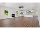 Open-concept living room with fireplace, leading into a kitchen with pendant lighting and modern finishes at 1503 Red Bluff Rd., Loris, SC 29569