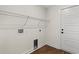 Mud room with wood floors features overhead shelving and utility hookups at 1503 Red Bluff Rd., Loris, SC 29569