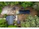 Aerial view of a property with multiple outbuildings, lawn furniture, and mature trees at 1521 Front St., Georgetown, SC 29440