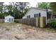 View of the backyard with a wooden fence and additional outdoor building at 1521 Front St., Georgetown, SC 29440