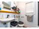 Bathroom equipped with a pedestal sink, toilet, and a window providing natural light at 1521 Front St., Georgetown, SC 29440