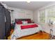 Bedroom showcasing hardwood floors and a comfortably decorated bed with a black headboard at 1521 Front St., Georgetown, SC 29440