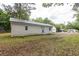 Exterior of home and spacious lawn with mature trees at 1521 Front St., Georgetown, SC 29440