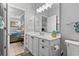 Neutral bathroom with a vanity, modern fixtures, and a view into an adjacent bedroom at 1525 Lanterns Rest Rd. # 103, Myrtle Beach, SC 29579