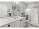 Bright bathroom featuring a glass enclosed shower, large mirror, and vanity with white cabinets at 1525 Lanterns Rest Rd. # 103, Myrtle Beach, SC 29579