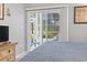 Bedroom with a view to the outdoor patio, tiled floor, and dresser with TV at 1525 Lanterns Rest Rd. # 103, Myrtle Beach, SC 29579