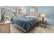 Bedroom with wood-look tile flooring, quilt-covered bed, and sliding door access to outdoor patio at 1525 Lanterns Rest Rd. # 103, Myrtle Beach, SC 29579