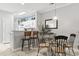 Dining area adjacent to the kitchen featuring a glass top table, seating for six, and stylish coastal decor at 1525 Lanterns Rest Rd. # 103, Myrtle Beach, SC 29579