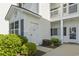 Close-up of a white entrance with door number and lush green bushes at 1525 Lanterns Rest Rd. # 103, Myrtle Beach, SC 29579