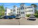 Three-story white condo building with black shutters and multiple parking spaces at 1525 Lanterns Rest Rd. # 103, Myrtle Beach, SC 29579