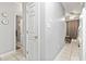 Hallway with a neutral wall color, tiled floors, and white doors at 1525 Lanterns Rest Rd. # 103, Myrtle Beach, SC 29579