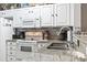 Bright kitchen featuring white cabinets, stainless steel sink, and granite countertops at 1525 Lanterns Rest Rd. # 103, Myrtle Beach, SC 29579