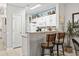 Bright kitchen with white cabinets, granite countertops, breakfast bar, and decorative coastal wall decor at 1525 Lanterns Rest Rd. # 103, Myrtle Beach, SC 29579