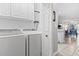 Laundry room with white appliances and wire shelving, next to the kitchen at 1525 Lanterns Rest Rd. # 103, Myrtle Beach, SC 29579