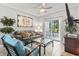 Comfortable living room with tile floors, decorative wall art, and access to outdoor patio at 1525 Lanterns Rest Rd. # 103, Myrtle Beach, SC 29579