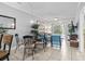 Living area with glass table, comfortable seating, tile floors, and sliding door to patio at 1525 Lanterns Rest Rd. # 103, Myrtle Beach, SC 29579