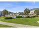 Community pool area with white fencing, palm trees, and lush landscaping, perfect for relaxation at 1525 Lanterns Rest Rd. # 103, Myrtle Beach, SC 29579