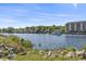 Scenic waterfront view with lush vegetation and a boat cruising along the tranquil waterway at 1525 Lanterns Rest Rd. # 103, Myrtle Beach, SC 29579
