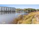 Beautiful waterfront view showcasing condo buildings and boat docks along the tranquil waterway at 1525 Lanterns Rest Rd. # 103, Myrtle Beach, SC 29579