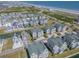 Stunning aerial view showcasing beachside houses with beautiful landscaping, a pond, and ocean views at 156 Via Old Sound Blvd. # C, Ocean Isle Beach, NC 28469