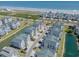 Aerial view of beachside homes with lush landscaping, serene ponds, and stunning ocean views at 156 Via Old Sound Blvd. # C, Ocean Isle Beach, NC 28469