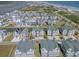 Beautiful aerial view featuring beachside homes with landscaping, a pond, and ocean vistas at 156 Via Old Sound Blvd. # C, Ocean Isle Beach, NC 28469