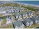 Stunning aerial view showcasing beachside houses with beautiful landscaping, a pond, and ocean views at 156 Via Old Sound Blvd. # C, Ocean Isle Beach, NC 28469
