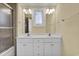 Well-lit bathroom featuring a double sink vanity and a glass-enclosed shower at 156 Via Old Sound Blvd. # C, Ocean Isle Beach, NC 28469
