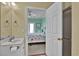 Well-lit bathroom showing a shower and bathtub combination connected to the bedroom at 156 Via Old Sound Blvd. # C, Ocean Isle Beach, NC 28469