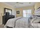 Comfortable bedroom with natural light, ceiling fan, and a TV on the dresser at 156 Via Old Sound Blvd. # C, Ocean Isle Beach, NC 28469