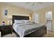 Bedroom with ceiling fan, side tables and lamps, and view of the mini-fridge and microwave area at 156 Via Old Sound Blvd. # C, Ocean Isle Beach, NC 28469