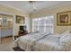 Bedroom with a ceiling fan, window with blinds, and a television with an attached bathroom at 156 Via Old Sound Blvd. # C, Ocean Isle Beach, NC 28469