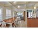 Open-concept dining area flowing into living space, perfect for entertaining guests, features tray ceilings at 156 Via Old Sound Blvd. # C, Ocean Isle Beach, NC 28469