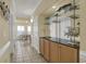 Bright hallway with tile flooring, built in bar with countertop, and dining area in the background at 156 Via Old Sound Blvd. # C, Ocean Isle Beach, NC 28469