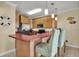 Well-equipped kitchen with wood cabinets, modern appliances, bar seating and colorful decorative accents at 156 Via Old Sound Blvd. # C, Ocean Isle Beach, NC 28469