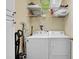 Bright laundry room with washer, dryer, and shelving for storage solutions at 156 Via Old Sound Blvd. # C, Ocean Isle Beach, NC 28469