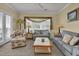 Cozy living room with comfortable seating, a ceiling fan, and bright windows at 156 Via Old Sound Blvd. # C, Ocean Isle Beach, NC 28469