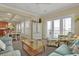 Open living and dining area with neutral tones, ceiling fan, and plenty of natural light at 156 Via Old Sound Blvd. # C, Ocean Isle Beach, NC 28469