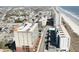 An aerial view of a multi-story building near the beach, highlighting its proximity to the coastline and surrounding neighborhood at 1707 Perrin Dr. # 1003, North Myrtle Beach, SC 29582
