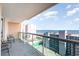 This large balcony features a glass railing with seating and ocean views at 1707 Perrin Dr. # 1003, North Myrtle Beach, SC 29582